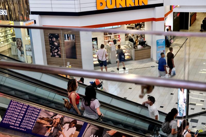 FILE - In this Aug. 7, 2019, file photo shoppers ride an escalator inside the Glendale Galleria in Glendale, Calif. On Tuesday, Aug. 27, the Conference Board releases its August index on U.S. consumer confidence. (AP Photo/Richard Vogel, File)