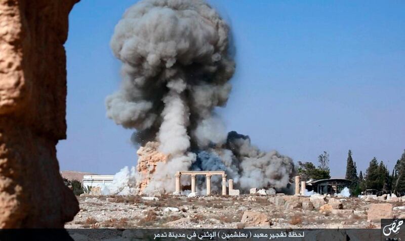 FILE - This undated photo released Tuesday, Aug. 25, 2015, file photo, on a social media site used by Islamic State militants, which has been verified and is consistent with other AP reporting, shows smoke from the detonation of the 2,000-year-old temple of Baalshamin in Syria's ancient caravan city of Palmyra. (Islamic State social media account via AP, File)