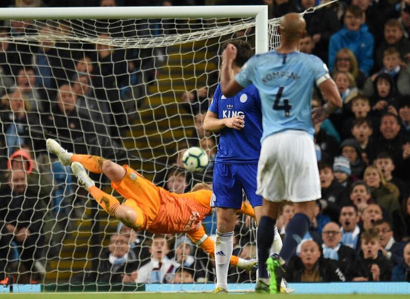 Manchester City's Belgian defender Vincent Kompany (R) watches as his shot beats Leicester City's Danish goalkeeper Kasper Schmeichel (L) to score the opening goal during the English Premier League football match between Manchester City and Leicester City at the Etihad Stadium in Manchester, north west England, on May 6, 2019. (Photo by Oli SCARFF / AFP) / RESTRICTED TO EDITORIAL USE. No use with unauthorized audio, video, data, fixture lists, club/league logos or 'live' services. Online in-match use limited to 120 images. An additional 40 images may be used in extra time. No video emulation. Social media in-match use limited to 120 images. An additional 40 images may be used in extra time. No use in betting publications, games or single club/league/player publications. / 