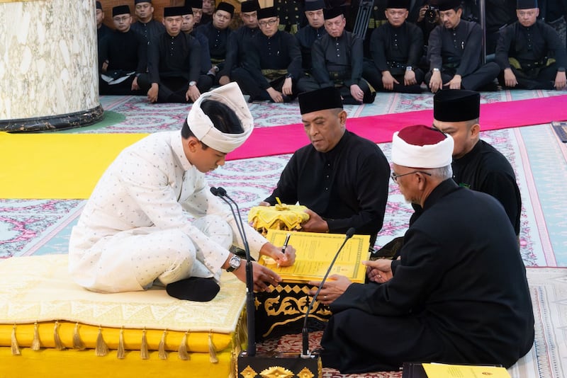 Prince Mateen signing documents after his solemnisation. Photo: Brunei's Information Department