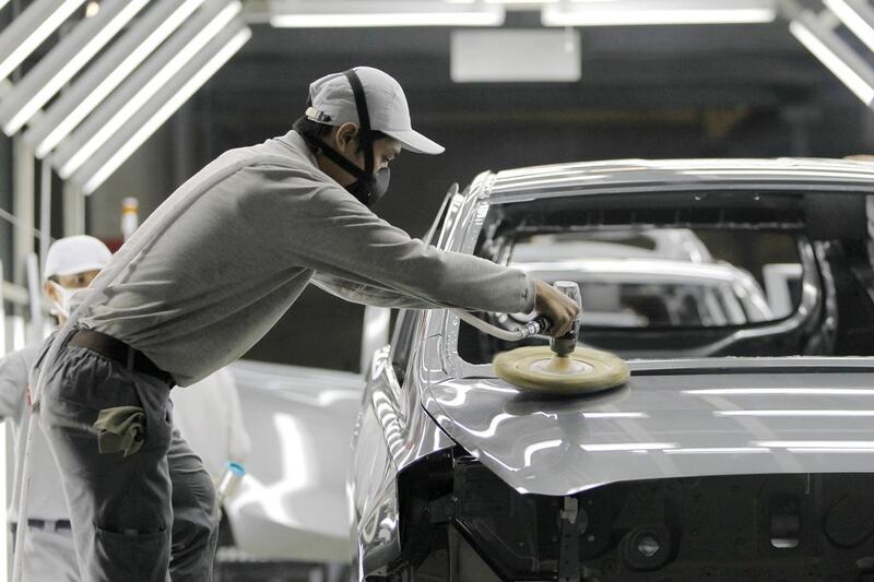A worker polishes a body of Datsun Go+ at an assembly line in the Nissan Indonesia factory. Beawiharta / Reuters