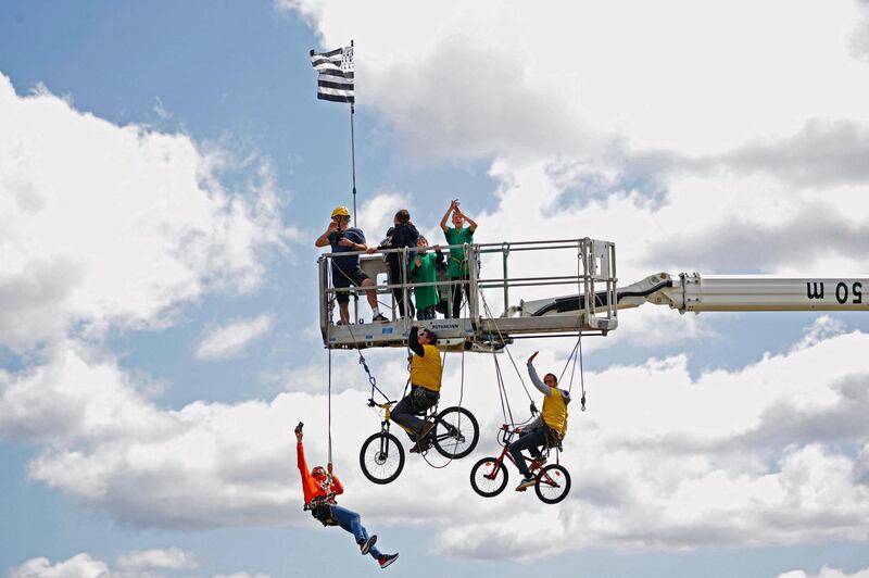 Spectators stand on a platform during the second stage of the Tour de France. AFP