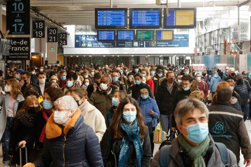 Parisians arrive to catch trains leaving from the Gare Montparnasse serving the west and southwest of France, in Paris. Parisians packed inter-city trains leaving the capital on March 19, 2021, hours ahead of a new lockdown in the French capital. AFP