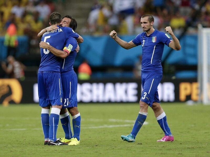 italy players Thiago Motta, left, Andrea Pirlo, centre, and Giorgio Chiellini, right, celebrate after beating England 2-1 at the 2014 World Cup on Saturday night in Manaus, Brazil. Marcio Jose Sanchez / AP