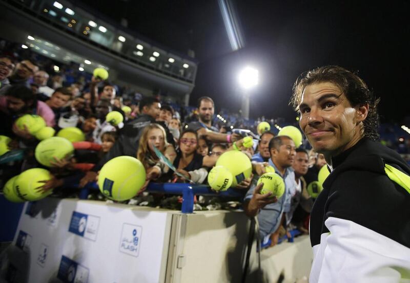 Rafael Nadal signs autographs after defeating Milos Raonic of Canada in the final. Ali Haider / EPA