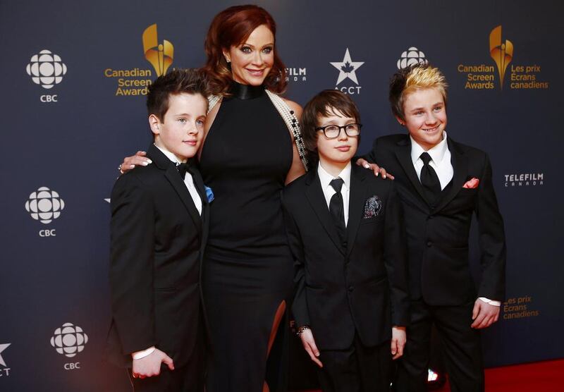 Actress Lauren Holly and her sons arrive on the red carpet. Mark Blinch / Reuters