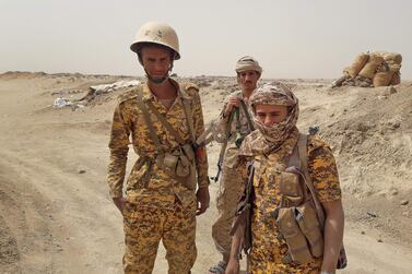 Troops loyal to Yemen's Saudi-backed government look on while at a position against the Houthi rebels at the Kanais frontline in the north of the contested province of Marib. AFP  