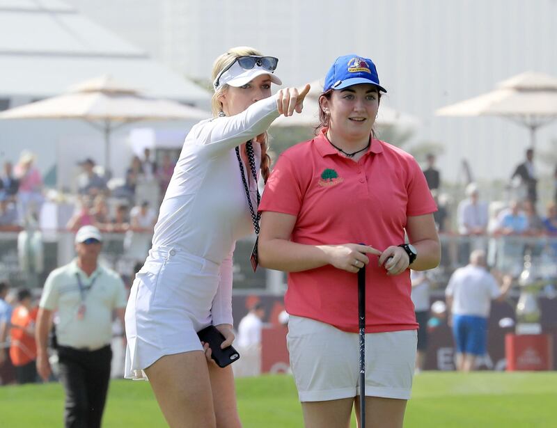 Saoirse Lambe of Ireland, who won a global competition to play with Rory McIlroy and Niall Horan, is assited by Paige Spiranac during the pro-am at Emirates Golf Club. David Cannon / Getty Images