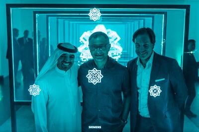 Siemens partnered with calligrapher and artist Wissam Shawkat, centre, to create Fabric, a unique perspective on the beauty, magic and vitality of numbers. With Shawkat are Helmut von Strove, chief executive of Siemens in the Middle East, right, and Khalid Al Ameri, an Emirati content creator. Photo: Siemens