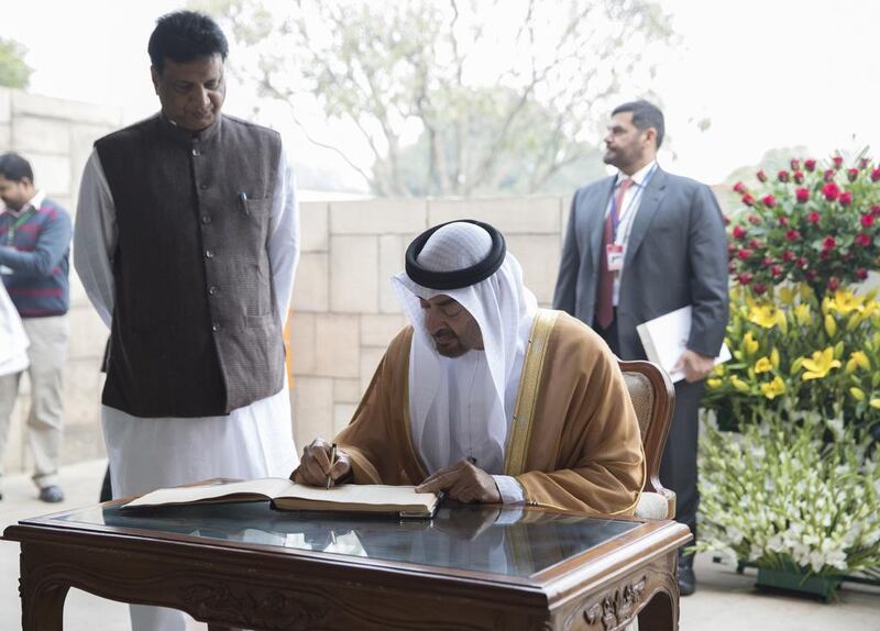 Sheikh Mohammed bin Zayed signs a guest book during a visit to Raj Ghat. Mohamed Al Hammadi / Crown Prince Court - Abu Dhabi