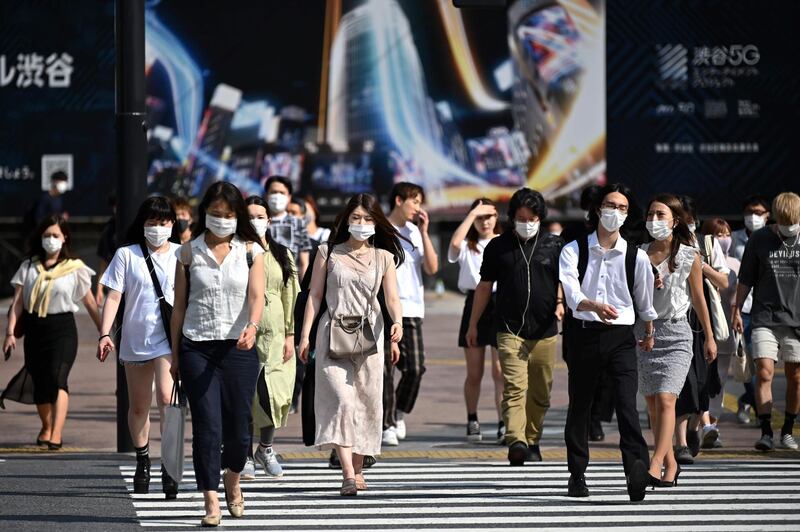 People walk across Shibuya crossing in Tokyo on June 8, 2020. / AFP / CHARLY TRIBALLEAU
