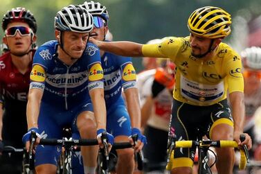 Julian Alaphilippe in the yellow jersey alongside defending Tour de France champion Geraint Thomas at the end of Stage 17. Reuters