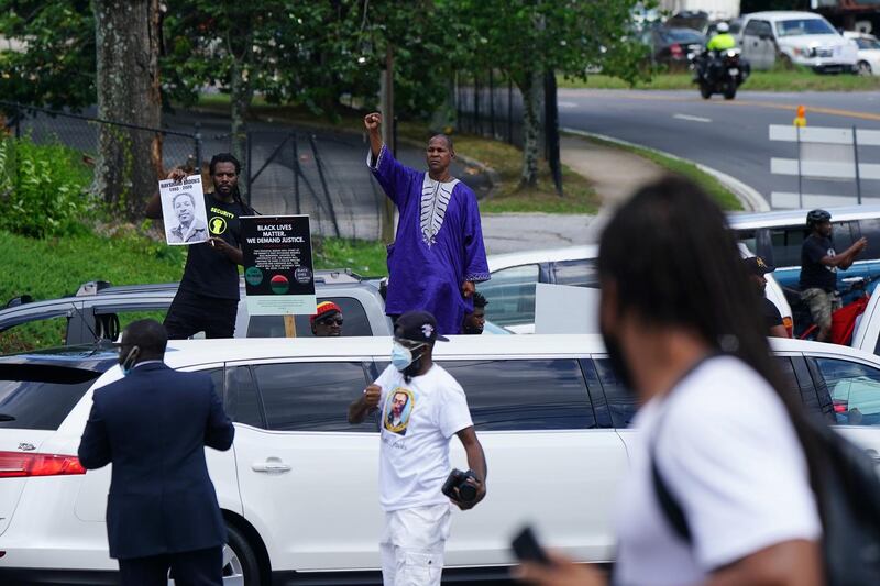 A man raises his fist during the funeral procession. Reuters