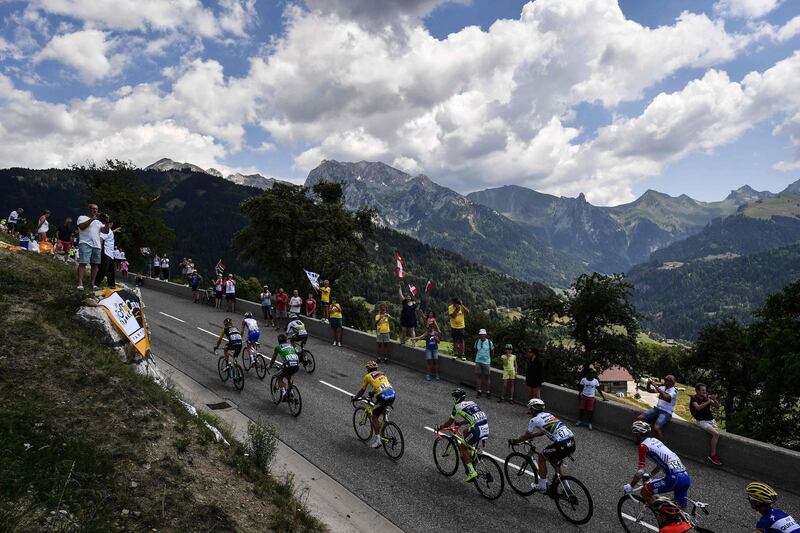 Belgium's Greg van Avermaet, centre, wearing the overall leader's yellow jersey, rides in a breakaway group during the 10th stage of the Tour de France between Annecy and Le Grand-Bornand. Jeff Pachoud / AFP