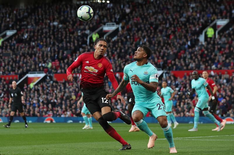 Manchester United's Chris Smalling, left, vies for the ball with Newcastle United's DeAndre Yedlin. AP Photo