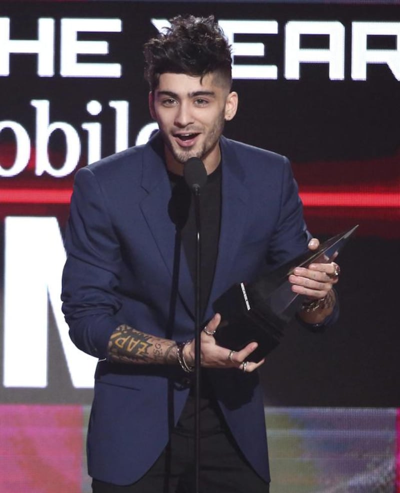 Zayn Malik accepts the award for new artist of the year at the American Music Awards in Los Angeles. Matt Sayles / Invision / AP