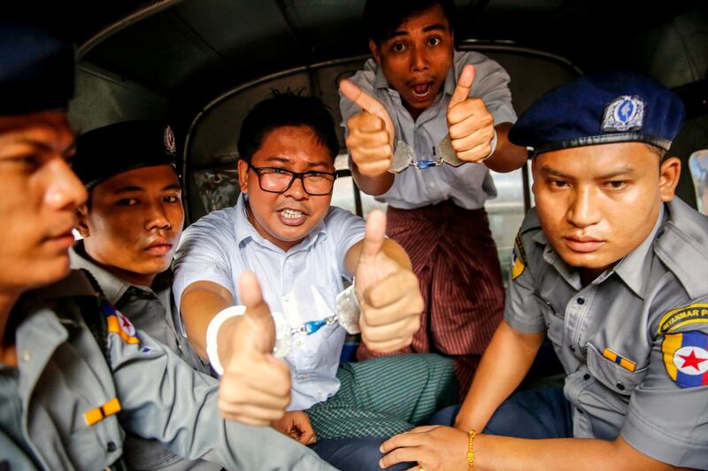 epaselect epa06993739 Reuters journalists Wa Lone (C) and Kyaw Soe Oo gesture as they prepare to leave the Insein township court in Yangon, Myanmar, 03 September 2018. Insein township court sentenced both Wa Lone and Kyaw Soe Oo to seven years prison after they were found guilty of violating a state secrets act while working on a story.  EPA/LYNN BO BO