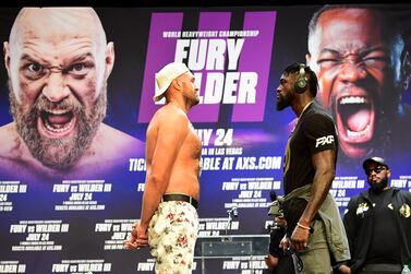 (FILES) In this file photo boxers Tyson Fury (L) and Deontay Wilder (R) face off at a press conference on June 15, 2021 in Los Angeles, California to announce their third WBC heavyweight championship ficght scheduled for July 24, 2021 in Las Vegas.  - A Covid-19 outbreak in Tyson Fury's camp is jeopardizing the World Boxing Council heavyweight champion's trilogy fight against Deontay Wilder on July 24, ESPN reported on July 8, 2021.  The US sports broadcaster, which has joint pay-per-view rights to the bout with Fox, said no official determination had yet been made but cited unnamed sources in saying the fight would "inevitably" be postponed.  (Photo by Frederic J.  BROWN  /  AFP)