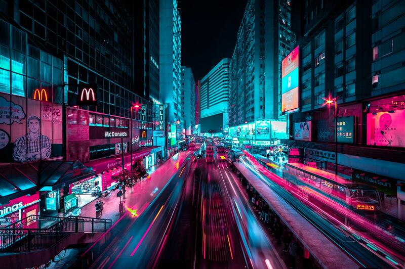 In 'Urban Artery', tramway, bus, cars and people are going through Causeway Bay like ghosts. Causeway Bay, Hong Kong. Photographer: Xavier Portela