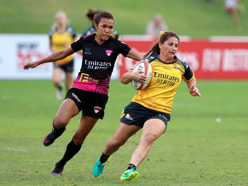 Dubai, United Arab Emirates - December 07, 2019: Bridie Johnson of Hurricanes beats the defence of the Emirates Firebirds Blue in the game between Dubai Hurricanes and Emirates Firebirds Blue in the Gulf womens final at the HSBC rugby sevens series 2020. Saturday, December 7th, 2019. The Sevens, Dubai. Chris Whiteoak / The National