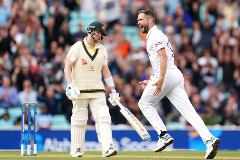 England's Chris Woakes celebrates taking the wicket of Australia's Steve Smith. PA 