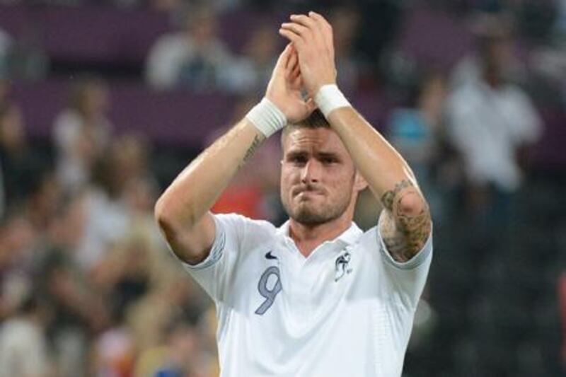 French forward Olivier Giroud salutes supporters at the end of the Euro 2012 football championships quarter-final match Spain vs France on June 23, 2012 at the Donbass Arena in Donetsk. AFP PHOTO / DAMIEN MEYER

