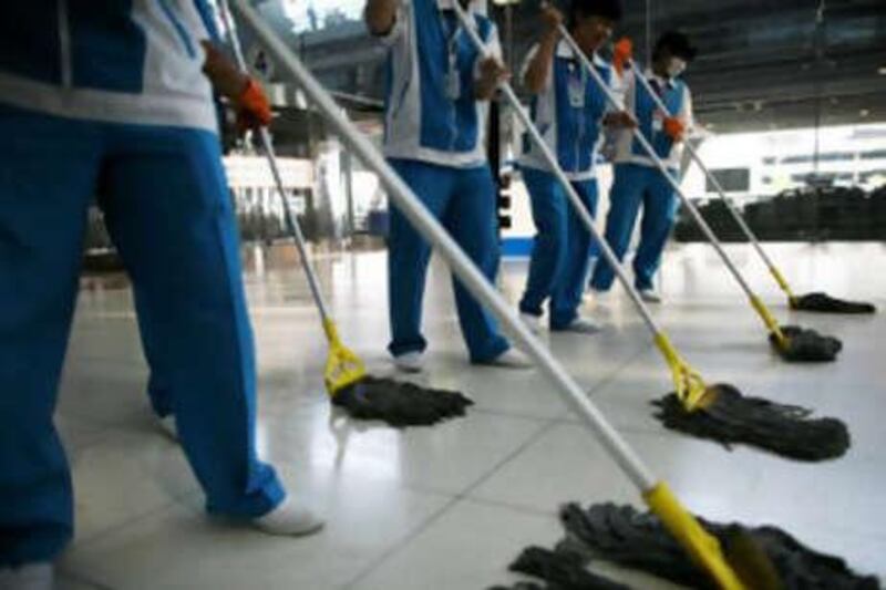 Thai workers clean the floor at Suvarnabhumi International Airport after the end of the seige.