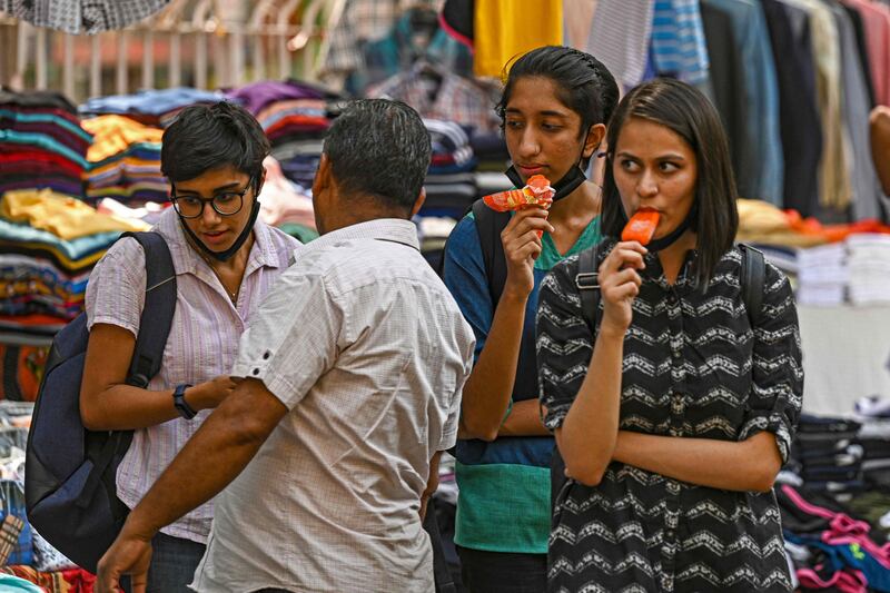 Girls shopping on a hot summer afternoon in New Delhi. AFP