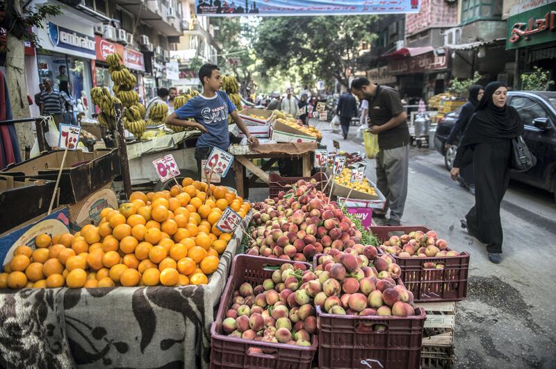 Egyptians walk at a market in the Egyptian capital, Cairo, on May 15, 2017.
Ramadan is a time for daytime fasting and lavish evening feasts, but Egyptians are scaling back preparations for the Muslim holy month this year after austerity measures fuelled decades-high inflation. / AFP PHOTO / KHALED DESOUKI