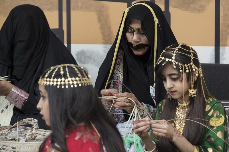 Women and girls weave handicrafts during a barza at Qasr Al Hosn. Ryan Carter / Crown Prince Court - Abu Dhabi