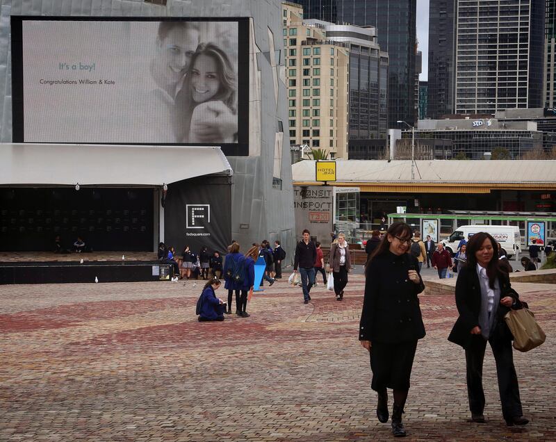 epa03797952 A message is displayed on a large screen at Melbourne's Federation Square offering congratulations on the arrival of Britain's Prince William and Princess Kate's baby boy, in Melbourne, Australia, 23 July 2013.  EPA/HAMISH BLAIR AUSTRALIA AND NEW ZEALAND OUT *** Local Caption ***  03797952.jpg