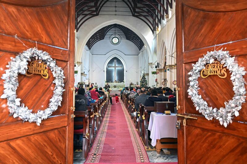 Christian devotees take part in a Christmas prayer at St John's Cathedral Church in Peshawar. AFP