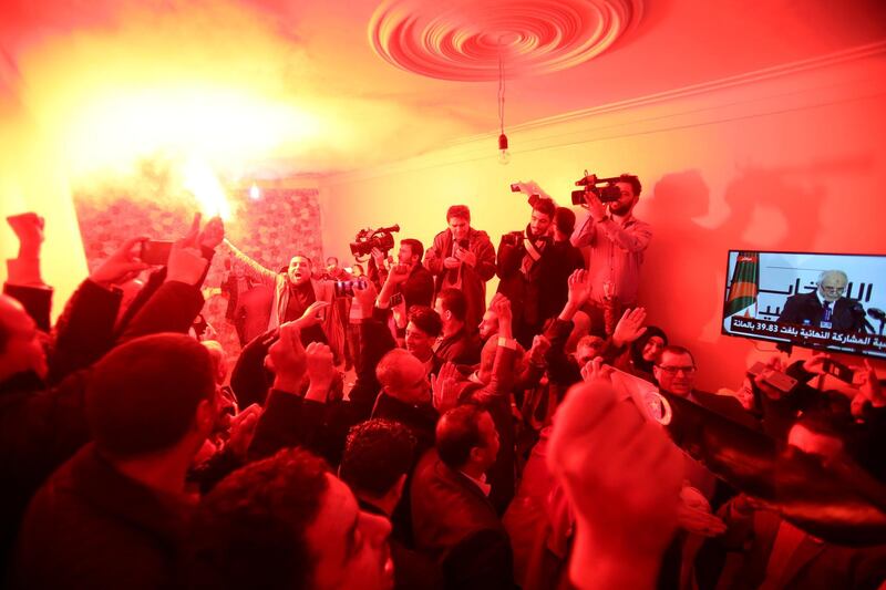 Supporters react at the campaign headquarters of Abdelmadjid Tebboune after he was announced as the new president in Algiers. Reuters