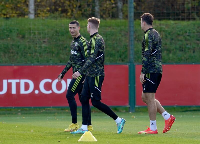 Manchester United's Cristiano Ronaldo with Scott McTominay during training. PA