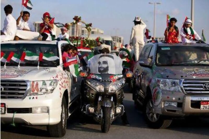 People show off their decorated cars during the Spirit of Union Parade at Yas Island.