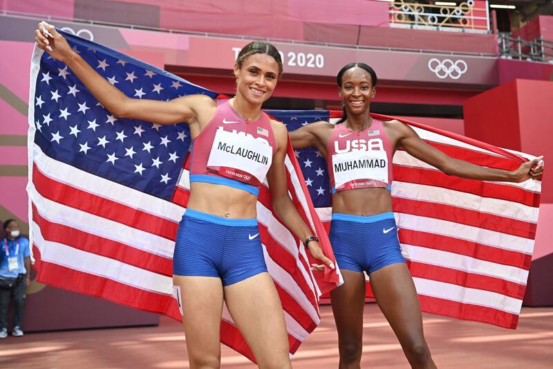 First-placed USA's Sydney Mclaughlin and second-placed USA's Dalilah Muhammad celebrate after competing in the women's 400m hurdles final.