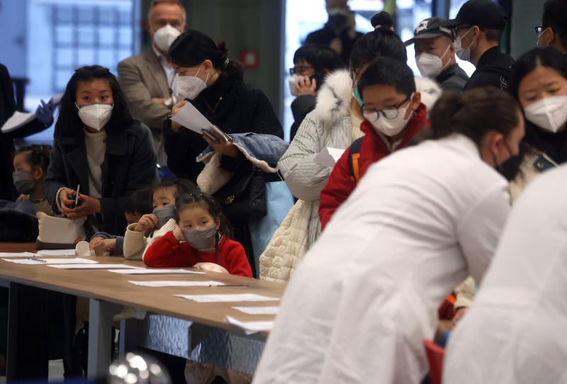 Travellers arriving from China line up for Covid testing in Malpensa Airport, in Milan. EPA
