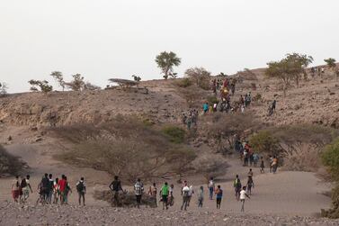 Ethiopian migrants are led by a smuggler to a disembarking point on the uninhabited coast outside the town of Obock, Djibouti in July. AP