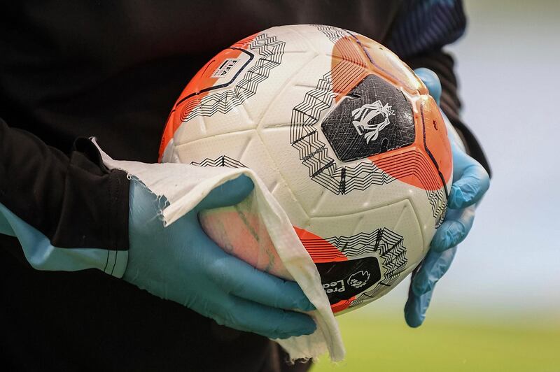A Manchester City staffer disinfects the ball prior the English Premier League match between Manchester City and Newcastle at the Ethiad Stadium in Manchester. AP