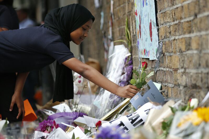 Children from Pakeman Primary School lay flowers in tribute to the victims of the terrorist attack in the Finsbury Park area of north London five years ago.  AFP