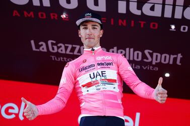 Valerio Conti celebrates on the podium after taking the pink jersey as the overall leader of the Giro d'Italia. AFP