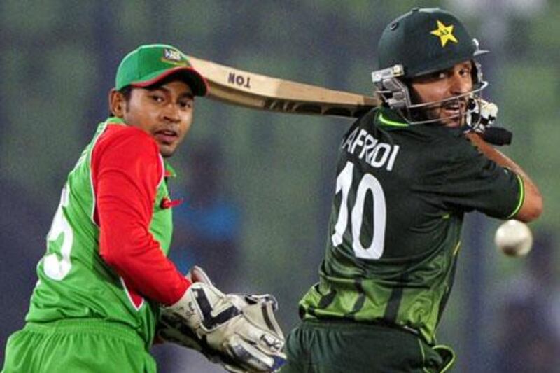 Shahid Afridi, right, plays a shot to lead Pakistan past captain Mushfiqur Rahim and Bangladesh.