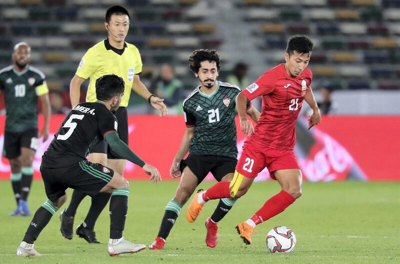 ABU DHABI , UNITED ARAB EMIRATES , January 21 ��� 2019 :- Khalfan Mubarak Al Shamsi ( no 21 in green UAE ) and Musabekov Farkhat ( no 21 in red of Kyrgyz Republic ) in action during the AFC Asian Cup UAE 2019 football match between UNITED ARAB EMIRATES vs. KYRGYZ REPUBLIC held at Zayed Sports City in Abu Dhabi. ( Pawan Singh / The National ) For News/Sports