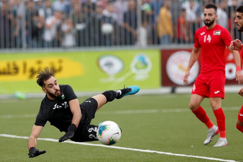 Palestine's goalkeeper Rami Hamada saves the ball- FIFA World Cup 2022 and Asian Cup Qualifier - Palestine v Saudi Arabia - Faisal Al-Husseini International Stadium, Al-Ram, West Bank. REUTERS