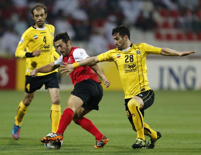 Al Ahli's Hugo Viana, centre, is targeting the AFC Champions League. AFP / April 1, 2014