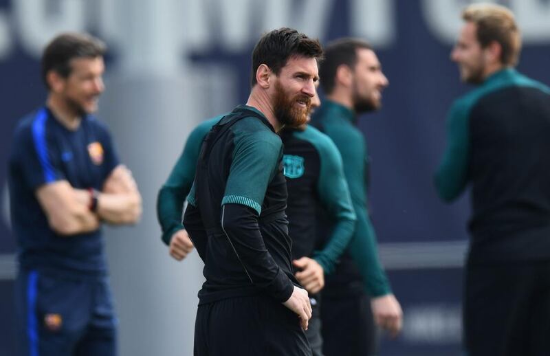 Lionel Messi looks on as teammates train. David Ramos / Getty Images