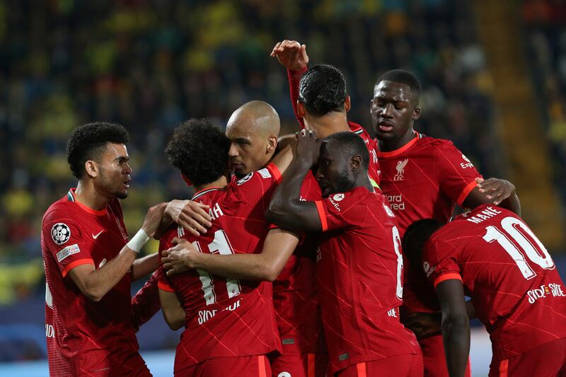 Fabinho celebrates with his teammates after scoring his side's opening goal. AP