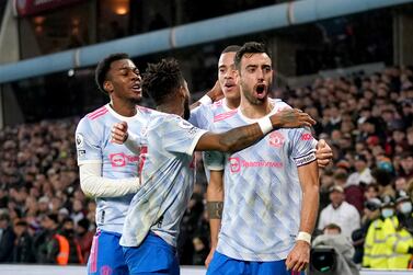 Manchester United's Bruno Fernandes (right) celebrates with his team-mates after scoring their side's second goal of the game during the Premier League match at Villa Park, Birmingham. Picture date: Saturday January 15, 2022.