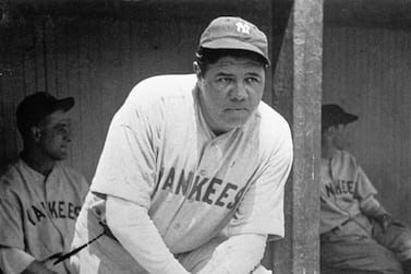 In this July 1929 file photo, New York Yankees' Babe Ruth, who was injured, stands in the dugout during a game at Cleveland. A Babe Ruth road jersey dating to 1928-30 has sold at auction for $5.6 million. AP Photo