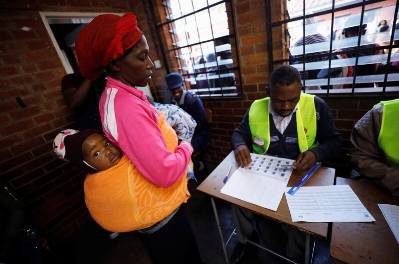 A Zimbabwean voter registers to cast her ballot in the country's general elections in Harare, Zimbabwe. REUTERS / Mike Hutchings
